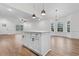Kitchen island with white cabinets and countertop and pendant lights overlooking the dining area at 334 William Nobles Rd., Aynor, SC 29511
