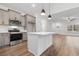 Modern kitchen with stainless steel appliances, pendant lights, and a center island with white countertop at 334 William Nobles Rd., Aynor, SC 29511