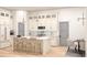 Open kitchen featuring white cabinets, a large island with seating, pendant lights and modern appliances at 346 Ridge Rd., Galivants Ferry, SC 29544