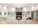 Bright living room featuring a modern fireplace, built-in shelving and plush white sofas at 346 Ridge Rd., Galivants Ferry, SC 29544