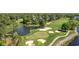 Scenic aerial view of a golf course with a pond and surrounding trees at 4771 Wild Iris Dr. # 204, Myrtle Beach, SC 29577