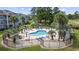 Aerial view of a community pool, landscaped grounds, palm trees and residential buildings at 4771 Wild Iris Dr. # 204, Myrtle Beach, SC 29577