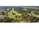 Aerial view showcasing a lush golf course and community with mature trees and ponds at 4771 Wild Iris Dr. # 204, Myrtle Beach, SC 29577