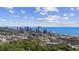 Aerial view of a city skyline on the ocean, with trees in the foreground at 4771 Wild Iris Dr. # 204, Myrtle Beach, SC 29577