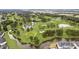 Aerial view of a lush green golf course with trees and winding water features at 4771 Wild Iris Dr. # 204, Myrtle Beach, SC 29577