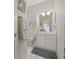 Bright bathroom with white fixtures, cabinets, and a large mirror at 4771 Wild Iris Dr. # 204, Myrtle Beach, SC 29577