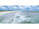 Aerial view of the serene beach and ocean with waves rolling in on a cloudy day at 4771 Wild Iris Dr. # 204, Myrtle Beach, SC 29577