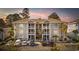 Three story condo building with parking in front and a colorful sunset sky at 4771 Wild Iris Dr. # 204, Myrtle Beach, SC 29577
