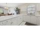 Bright and airy kitchen with white cabinets, island and open to living room at 4771 Wild Iris Dr. # 204, Myrtle Beach, SC 29577