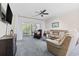 Inviting living room featuring comfortable seating and a sliding glass door to the outdoor patio at 4771 Wild Iris Dr. # 204, Myrtle Beach, SC 29577