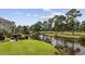 Beautiful water view of a pond and golf course surrounded by mature trees and a green landscape at 4771 Wild Iris Dr. # 204, Myrtle Beach, SC 29577