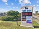 Sign for Food Lion and other businesses with a landscaped median, traffic, and sunny sky in the background at 4771 Wild Iris Dr. # 204, Myrtle Beach, SC 29577