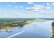 Aerial of a waterway with boats, lush green landscape, and a clear blue sky with white clouds at 4771 Wild Iris Dr. # 204, Myrtle Beach, SC 29577