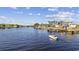 Scenic waterfront homes with boats docked in the calm water under a partly cloudy sky at 4771 Wild Iris Dr. # 204, Myrtle Beach, SC 29577