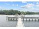 View from a dock, looking at a tour boat filled with people passing by a lush green shoreline at 4771 Wild Iris Dr. # 204, Myrtle Beach, SC 29577