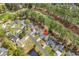 Aerial view of a neighborhood with a pond and a golf course in the background, surrounded by trees at 4738 Southern Trail, Myrtle Beach, SC 29579
