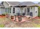 Cozy brick patio is great for outdoor entertaining, surrounded by well-maintained landscaping and mature trees at 4738 Southern Trail, Myrtle Beach, SC 29579