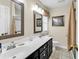 Well-lit bathroom featuring a double sink vanity, framed mirrors, and neutral-toned walls at 4738 Southern Trail, Myrtle Beach, SC 29579