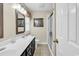 Modern bathroom with double vanity, new fixtures, framed mirror, and glass-enclosed shower at 4738 Southern Trail, Myrtle Beach, SC 29579