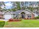 Charming single-story home featuring a manicured lawn, brick accents, and a well-maintained garden at 4738 Southern Trail, Myrtle Beach, SC 29579