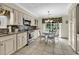 Kitchen featuring granite counters, tile backsplash, stainless appliances, and a cozy eat-in area with backyard views at 4738 Southern Trail, Myrtle Beach, SC 29579