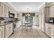 Well-lit kitchen features white cabinets, granite countertops, stainless steel appliances, and a cozy breakfast nook at 4738 Southern Trail, Myrtle Beach, SC 29579