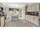 Eat-in kitchen featuring white cabinets, tile flooring, granite countertops, and stainless steel appliances at 4738 Southern Trail, Myrtle Beach, SC 29579
