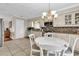 Updated kitchen featuring white cabinets, granite counters, a tile backsplash, and a round breakfast table at 4738 Southern Trail, Myrtle Beach, SC 29579