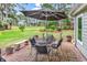 Brick patio with an umbrella and table provides a tranquil outdoor space with beautiful views of the green golf course at 4738 Southern Trail, Myrtle Beach, SC 29579