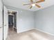 Bedroom with neutral paint and carpet, ceiling fan, and ensuite bathroom entrance at 503 Alston St., Conway, SC 29527