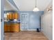 Eat-in kitchen with wooden cabinets, modern flooring, and a robot vacuum at 503 Alston St., Conway, SC 29527