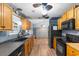 Long kitchen with wood cabinets, laminate flooring, and stainless steel appliances at 503 Alston St., Conway, SC 29527