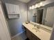 A well lit full bathroom features a large mirror, vanity with sink and overhead storage at 569 Blue River Ct. # 9-A, Myrtle Beach, SC 29579