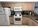 Efficient kitchen includes white appliances, granite countertops, and light wood cabinets at 569 Blue River Ct. # 9-A, Myrtle Beach, SC 29579