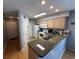 Well-lit kitchen features light wood cabinets, granite countertops, and white appliances at 569 Blue River Ct. # 9-A, Myrtle Beach, SC 29579
