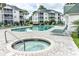 Community pool featuring a hot tub surrounded by patio furniture and lush landscaping at 569 Blue River Ct. # 9-A, Myrtle Beach, SC 29579