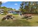Community area with picnic tables and grills with grassy grounds and apartments at 610 Putters Ln. # H-109, Little River, SC 29566