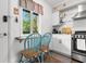 Well-lit kitchen featuring a window with a cozy breakfast bar and modern stainless steel appliances at 610 Putters Ln. # H-109, Little River, SC 29566