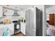 Updated kitchen featuring stainless steel appliances, white cabinetry, and open access to living area at 610 Putters Ln. # H-109, Little River, SC 29566