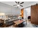 Modern living room with couch, a sliding barn door to the bedroom, and stylish decor at 610 Putters Ln. # H-109, Little River, SC 29566