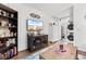 Bright living room with decorative shelving, a TV, decor, and an open entry at 610 Putters Ln. # H-109, Little River, SC 29566