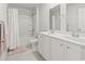 Bright bathroom features a double sink vanity, tiled floors and shower-tub combination at 7037 Grant St., Little River, SC 29566
