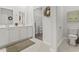 Bright bathroom featuring double vanity sinks, modern fixtures, and a linen closet for ample storage and convenience at 7037 Grant St., Little River, SC 29566