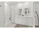 Modern bathroom featuring a glass-enclosed shower, double vanity sinks, and clean white finishes for a spa-like experience at 7037 Grant St., Little River, SC 29566