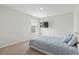 Cozy bedroom with plush carpet, features a mounted television and a sunlit window at 7037 Grant St., Little River, SC 29566