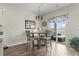 Bright breakfast nook featuring a round table, chairs, and sliding glass doors leading to outdoor seating at 7037 Grant St., Little River, SC 29566