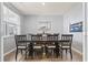 Formal dining room featuring a wooden table set with seating for eight, modern light fixtures, and stylish decor at 7037 Grant St., Little River, SC 29566