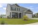 Charming two-story home with a well-manicured lawn, a brick and gray siding facade and welcoming front porch at 7037 Grant St., Little River, SC 29566