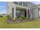 Inviting front porch with classic columns, decorative landscaping, and charming decor at 7037 Grant St., Little River, SC 29566