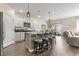 Spacious kitchen featuring stainless steel appliances, a granite island with barstool seating, and an adjacent dining area at 7037 Grant St., Little River, SC 29566